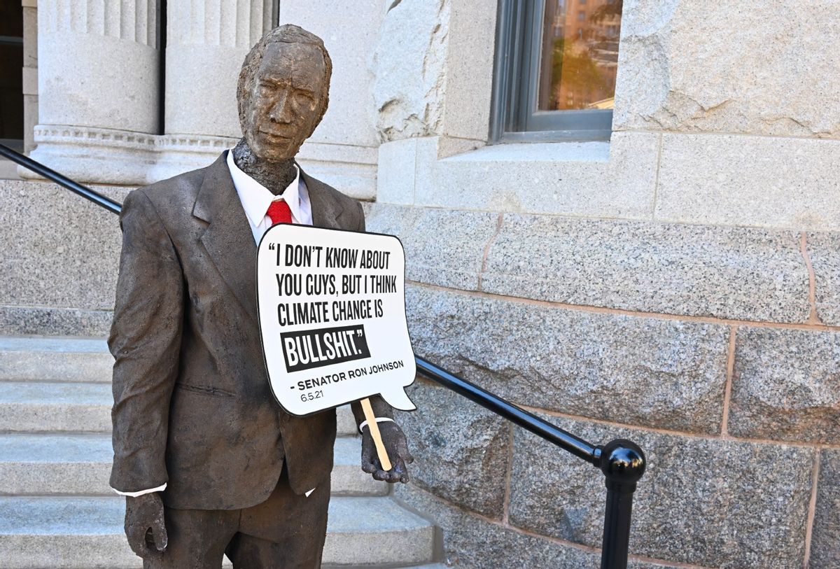 The art piece that highlights Senator Ron Johnson's views on climate change is being unveiled during MoveOn Press Conference and Rally on September 29, 2022 in Milwaukee, Wisconsin. (Daniel Boczarski/Getty Images for MoveOn)