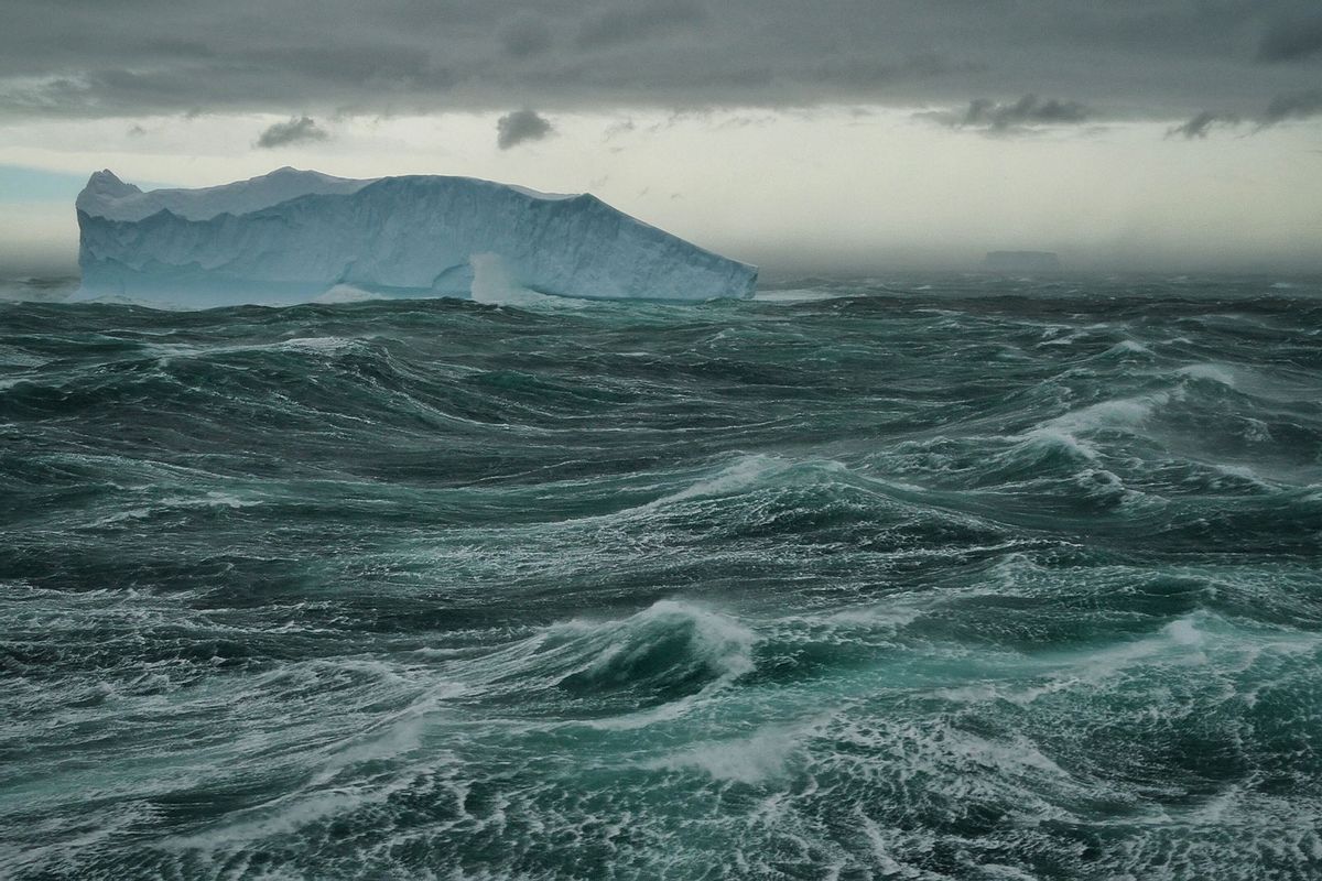 Tabular iceberg floats in a stormy green sea, Southern Ocean, Antarctica (Getty Images/Jeff Miller)