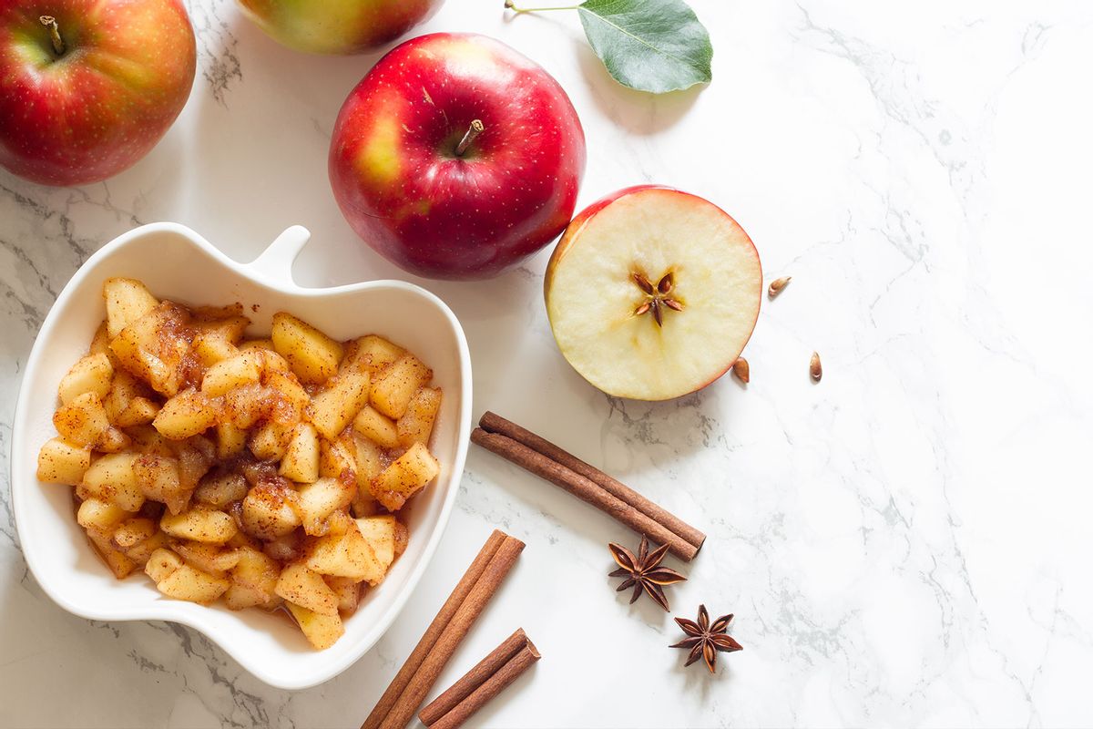 Apple chunks in a bowl with cinnamon (Getty Images/udra)