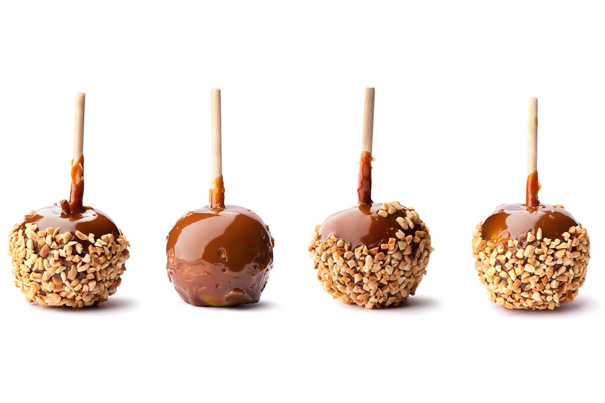 Four apples coated with caramel and three with nuts also (Getty Images/duckycards)