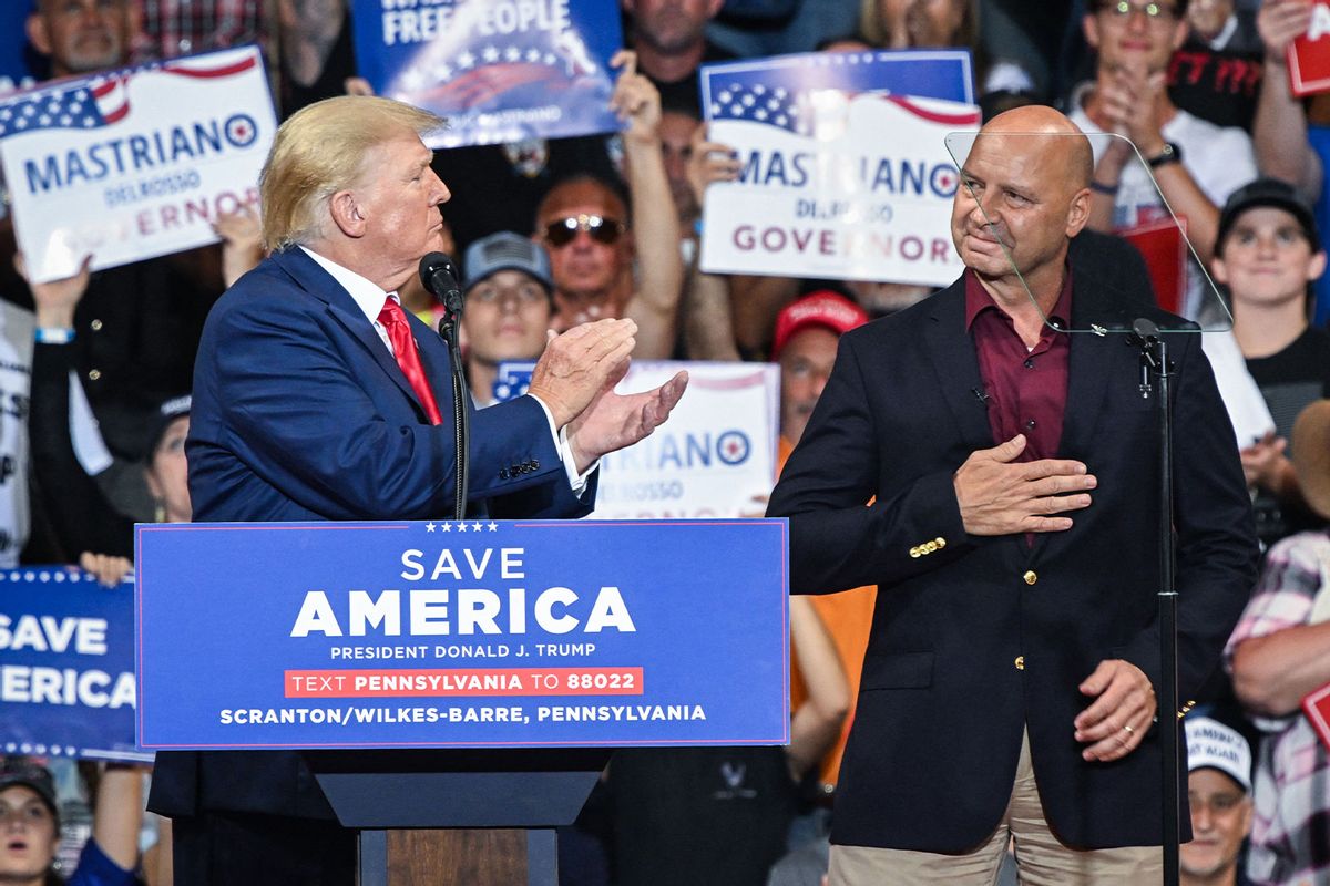 Former US President Donald Trump (L) applauds Pennsylvania gubernatorial candidate Doug Mastriano during a campaing rally in support of Mastriano and Mehmet Oz for US Senate at Mohegan Sun Arena in Wilkes-Barre, Pennsylvania on September 3, 2022. (ED JONES/AFP via Getty Images)