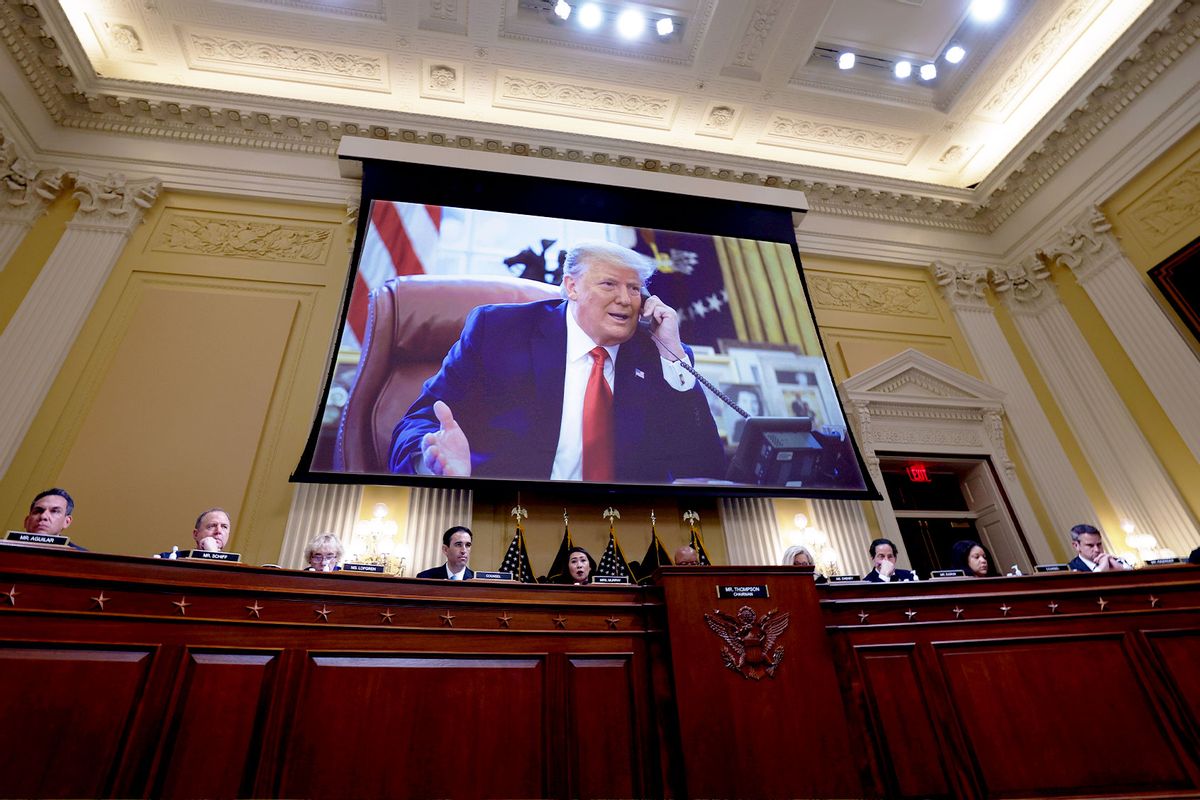 Former U.S. President Donald Trump appears on a video screen above members of the Select Committee to Investigate the January 6th Attack on the U.S. Capitol during the seventh hearing on the January 6th investigation in the Cannon House Office Building on July 12, 2022 in Washington, DC. (Kevin Dietsch/Getty Images)