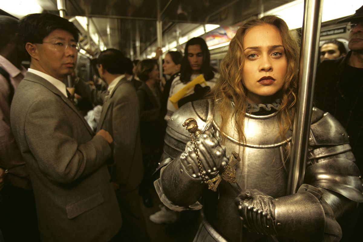 Singer Fiona Apple in an armor suit poses on a crowded New York subway, November, 1997 in New York. (Joe McNally/Getty Images)