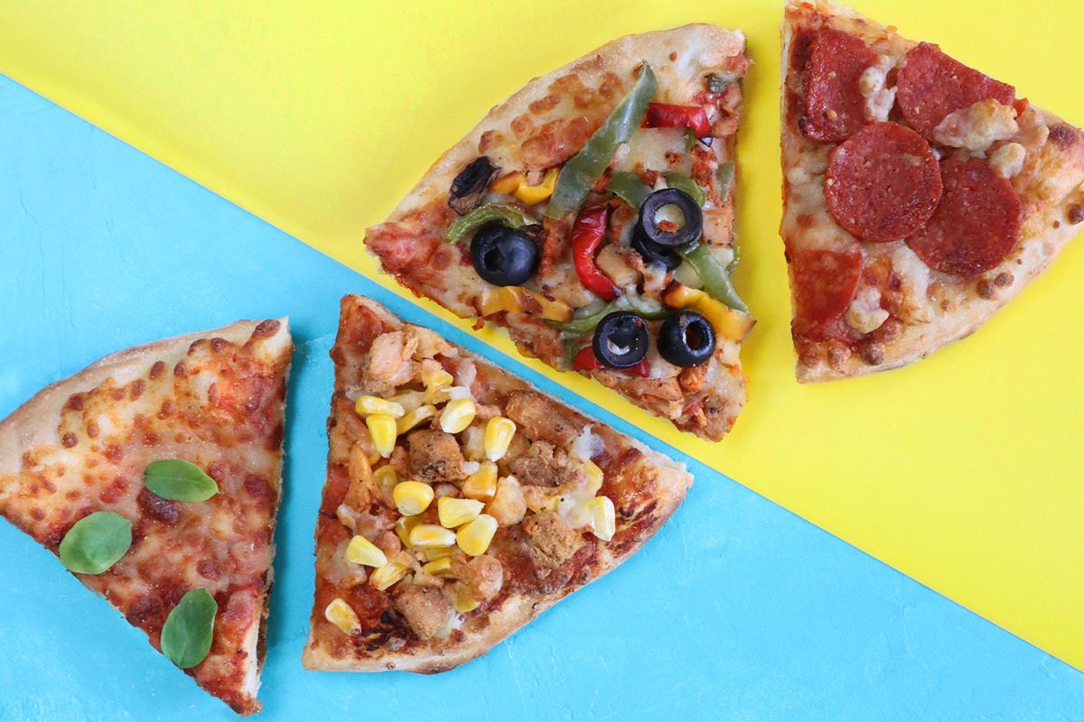 Slices of pizzas with different toppings including chicken and sweetcorn, pepperoni, vegetable and Pizza Margherita (Getty Images/mtreasure)