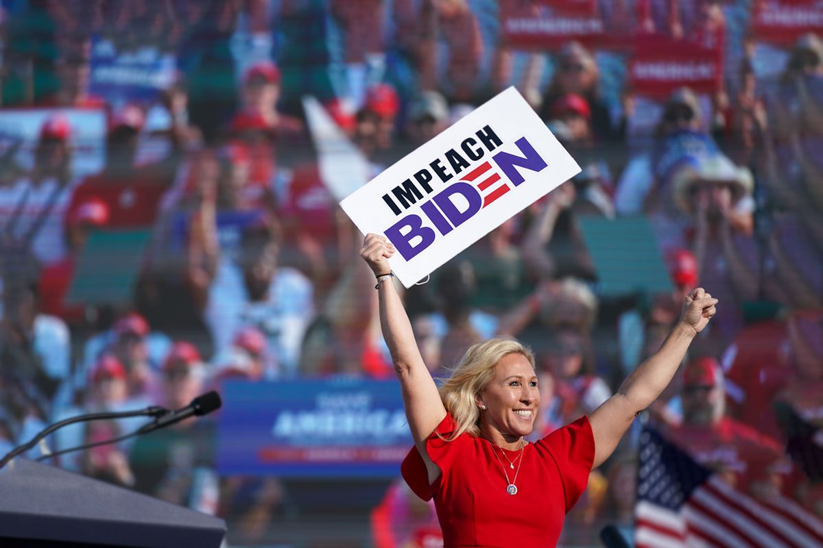 Rep. Marjorie Taylor Greene, R-Ga., holds a sign that reads "Impeach Biden" at a rally featuring Donald Trump on Sept. 25, 2021, in Perry, Georgia. (Sean Rayford/Getty Images)