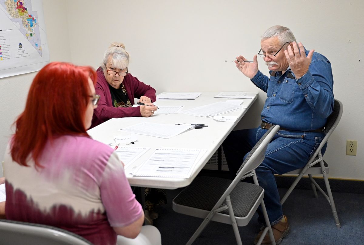 Volunteers Kathleen OConnor (C) and Don McCallum (R) look to reader Jean Kocvara during a training session for hand counting voters ballots at a Nye County government building in Pahrump, Nevada on October 15, 2022. Due to a mistrust of ballot machines, the county chose to hand count ballots for the upcoming general election on Nov. 8. (David Becker for the Washington Post/Getty Images)