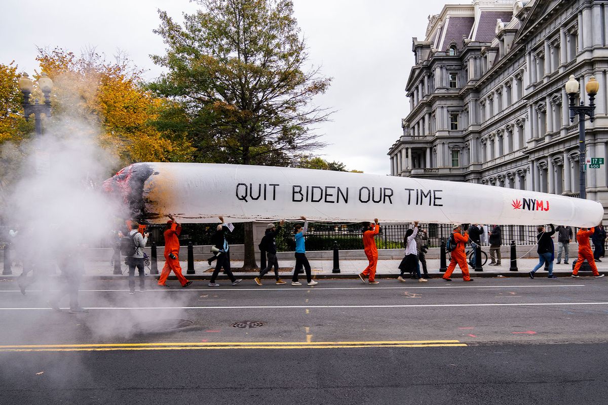 Cannabis activists carry a blow-up joint on 17th Street NW, outside of the Eisenhower Executive Office Building during a rally to call for the Biden administration to release prisoners convicted of federal marijuana crimes on Monday, October 24, 2022. (Tom Williams/CQ-Roll Call, Inc via Getty Images)