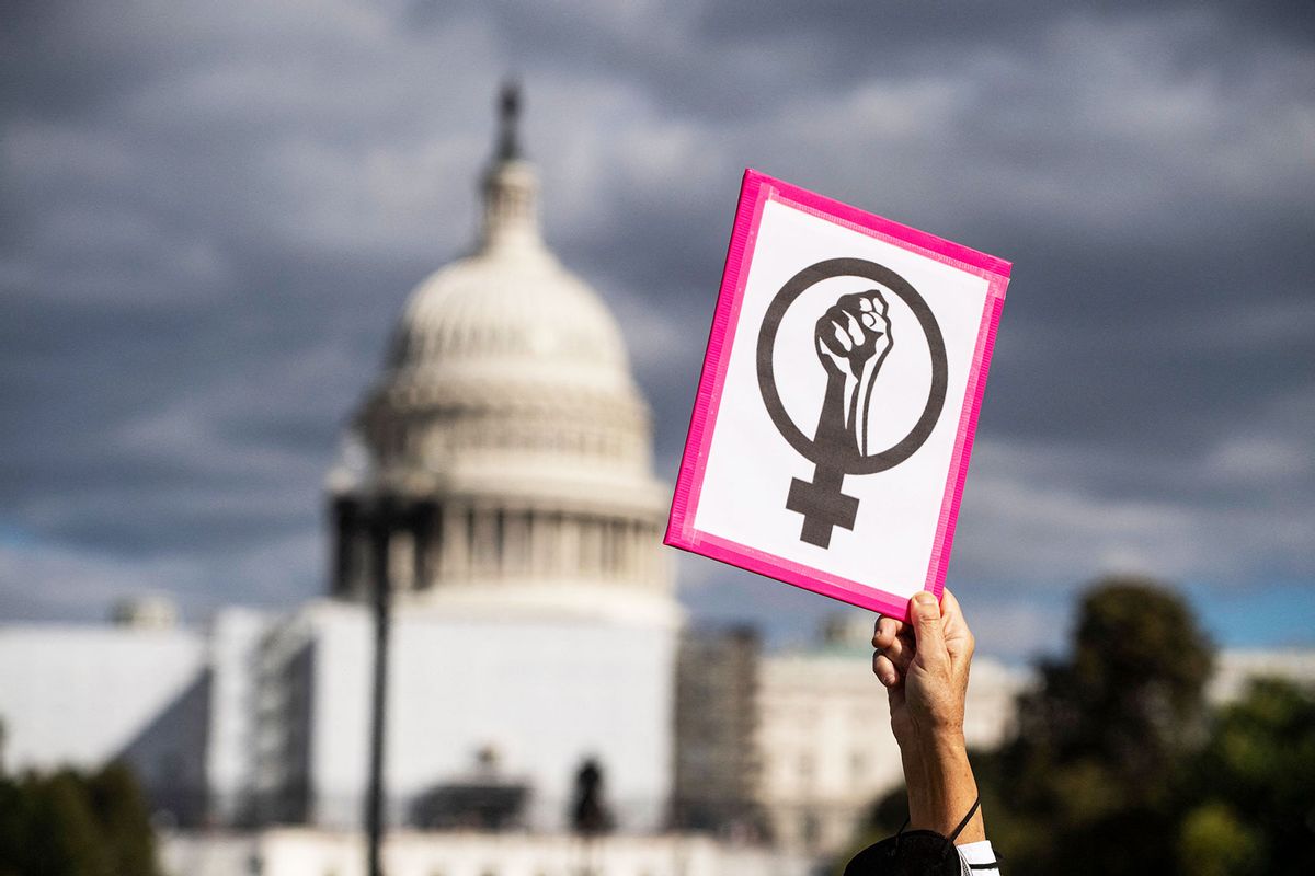 An abortion rights demonstrator holds a sign near the US Capitol during the annual Women's March to support Women's Rights in Washington, DC, October 8, 2022. (ROBERTO SCHMIDT/AFP via Getty Images)