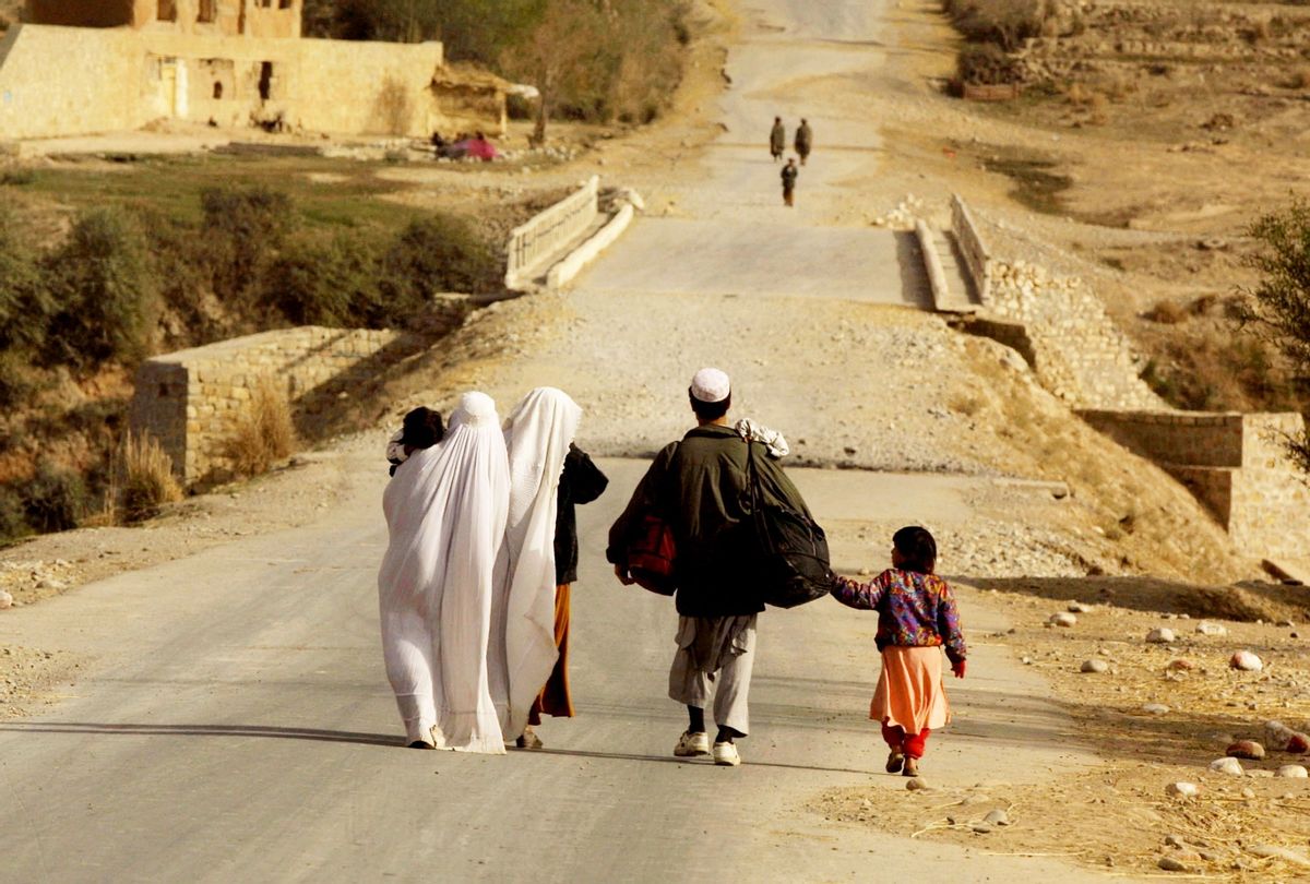 A refugee family flees the village of Khanabad in Afghanistan. (Sion Touhig/Getty Images)