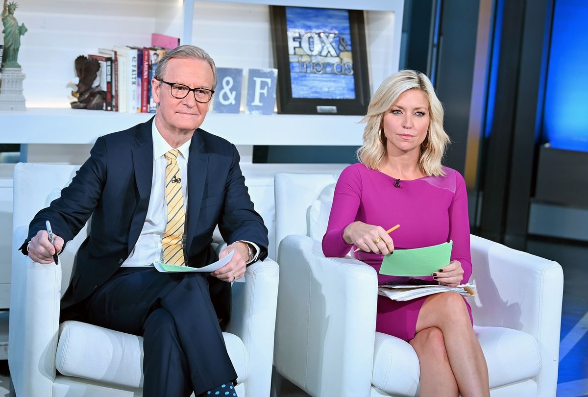 Steve Doocy and Ainsley Earhardt host "FOX & Friends" at Fox News Channel Studios in New York City.  (Slaven Vlasic/Getty Images)