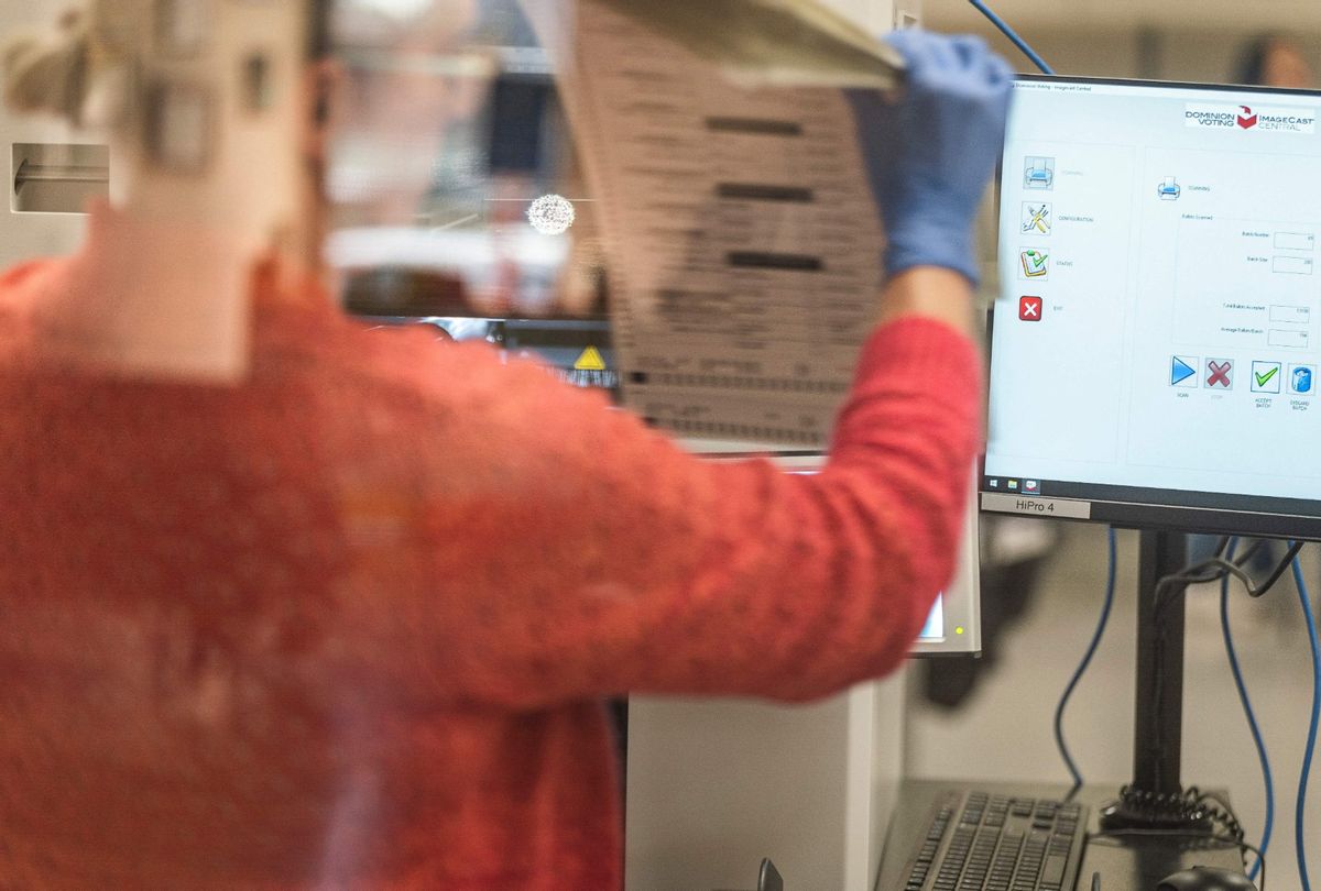 A poll worker handles ballots for the midterm election at the Maricopa County Tabulation and Elections Center in Phoenix, Arizona, on October 25, 2022. (OLIVIER TOURON/AFP via Getty Images)