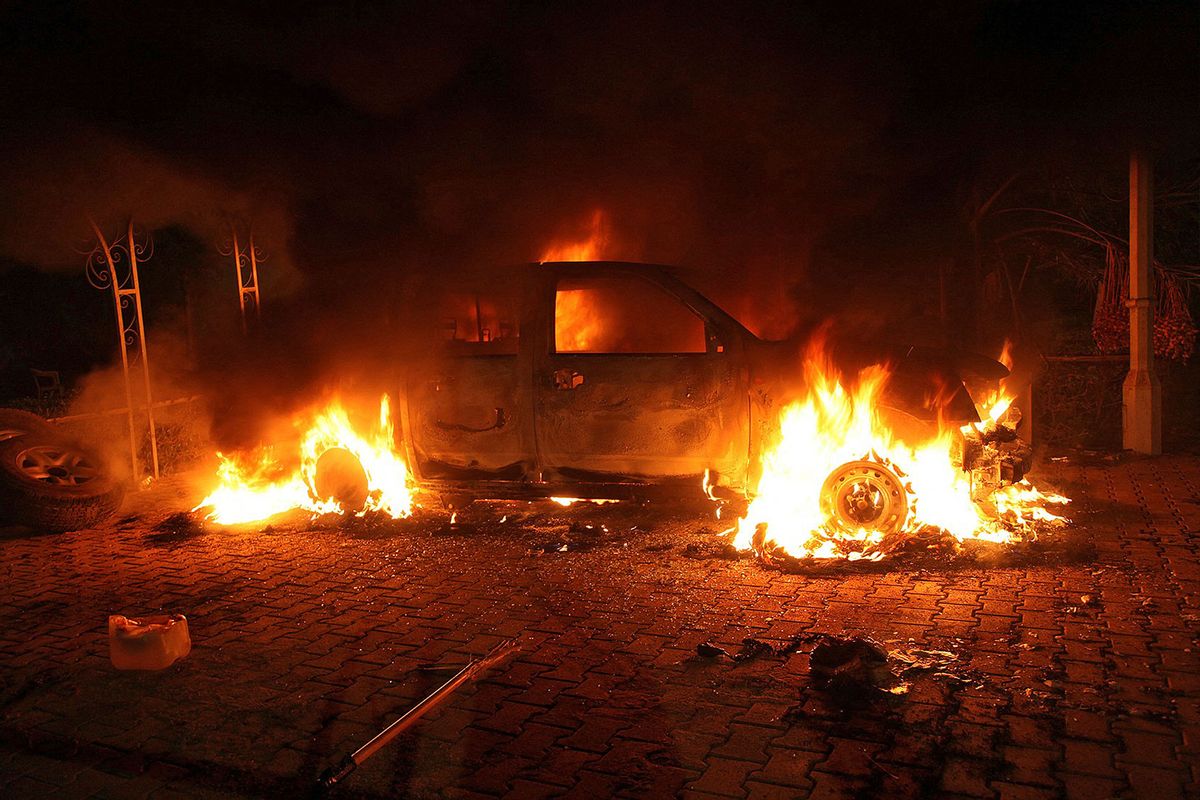 A vehicle and the surrounding area are engulfed in flames after it was set on fire inside the U.S. consulate compound in Benghazi, Libya, on Sept. 11, 2012.  (STR/AFP via Getty Images)