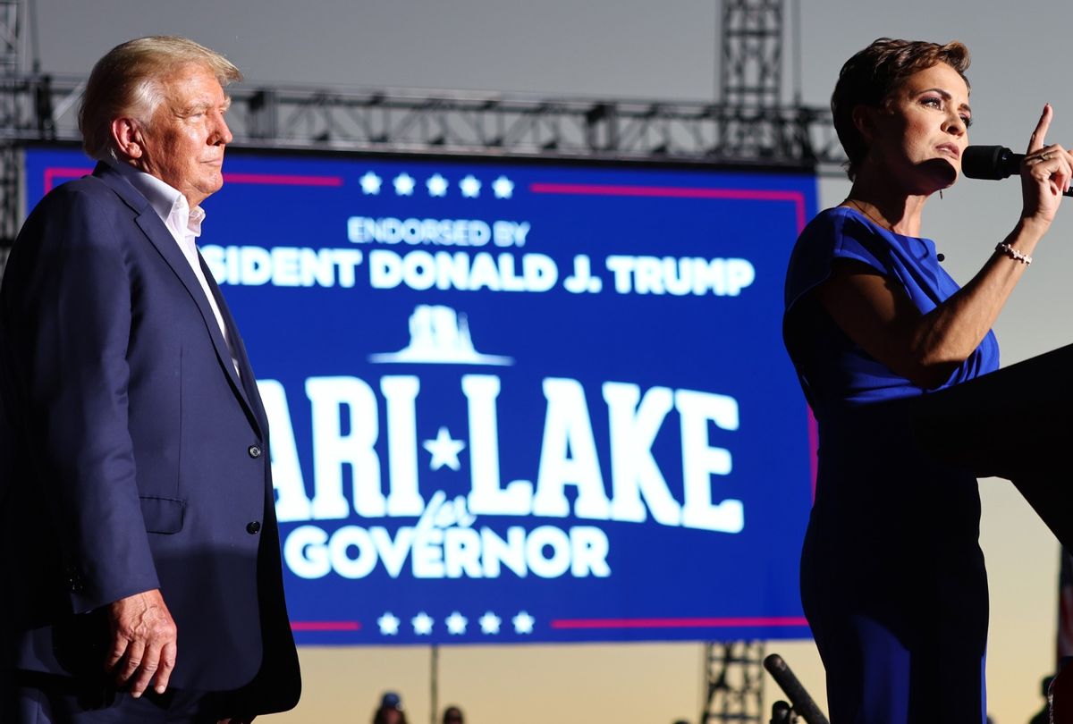 Former President Donald Trump looks on as Arizona Republican nominee for governor Kari Lake speaks during a campaign rally on October 09, 2022 in Mesa, Arizona.  (Mario Tama/Getty Images)