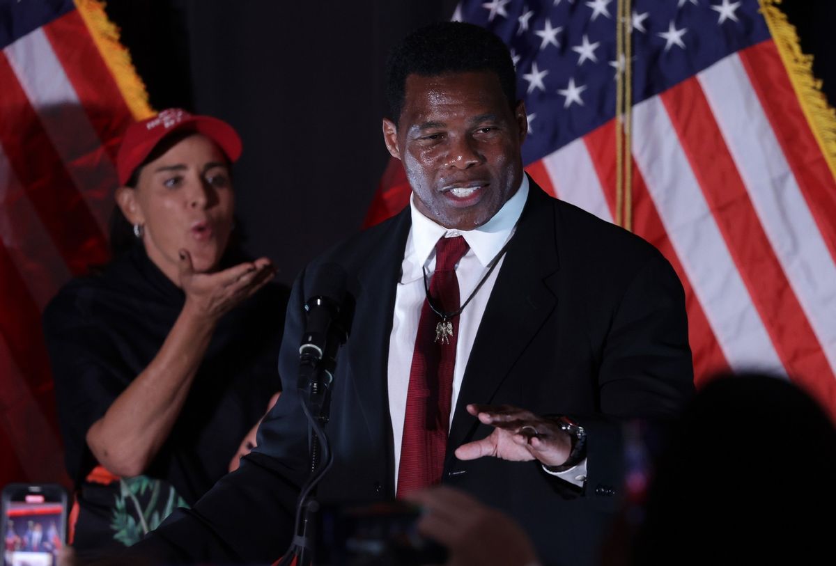 Republican U.S. Senate candidate Herschel Walker speaks to supporters as his wife Julie Blanchard looks on during an election night event on November 8, 2022 in Atlanta, Georgia.  (Alex Wong/Getty Images)