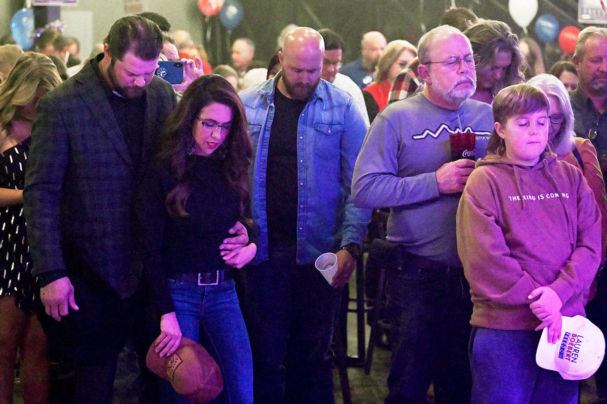Jayson Boebert puts his arms around his wife Republican Congresswoman Lauren Boebert as they pray during an Election night party at Warehouse 2565 on November 8, 2022 in Grand Junction, Colorado. (RJ Sangosti/MediaNews Group/The Denver Post via Getty Images)