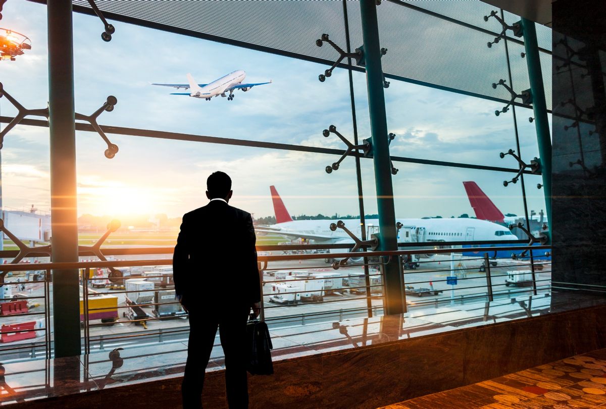 Man waits for flight at airport. (guvendemir/Getty Images)