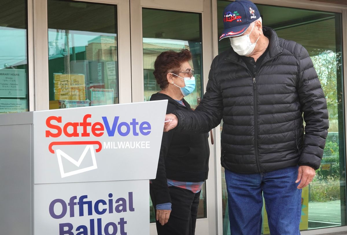 Residents drop mail-in ballots in an official ballot box outside of the Tippecanoe branch library on October 20, 2020 in Milwaukee, Wisconsin. (Scott Olson/Getty Images)