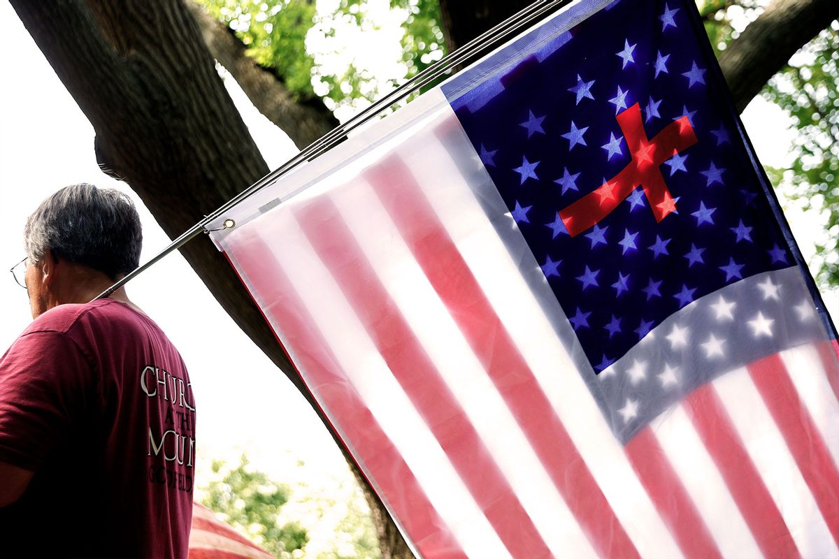 A United States and Christian flag are sandwiched together (Chip Somodevilla/Getty Images)