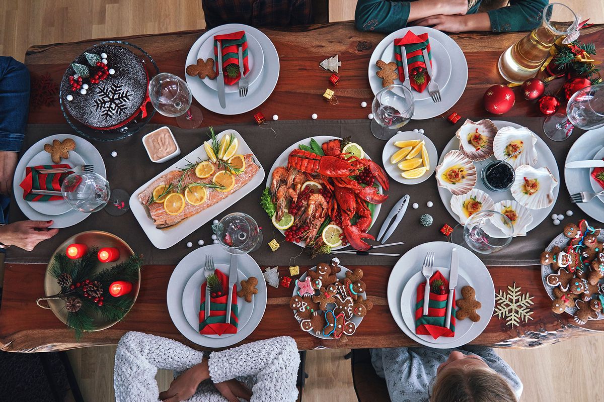 Christmas Dinner with Salmon Fish Fillet, Scallops, Lobster, Shrimps and Christmas Cake (Getty Images/GMVozd)