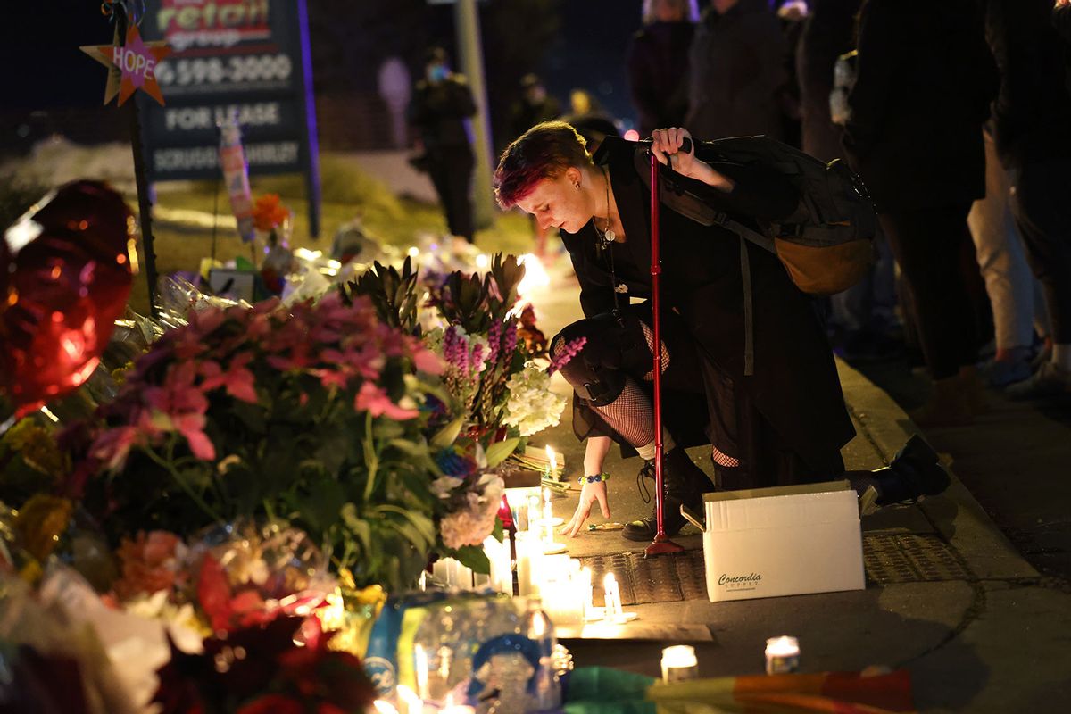People hold a vigil at a makeshift memorial near the Club Q nightclub on November 20, 2022 in Colorado Springs, Colorado. (Scott Olson/Getty Images)