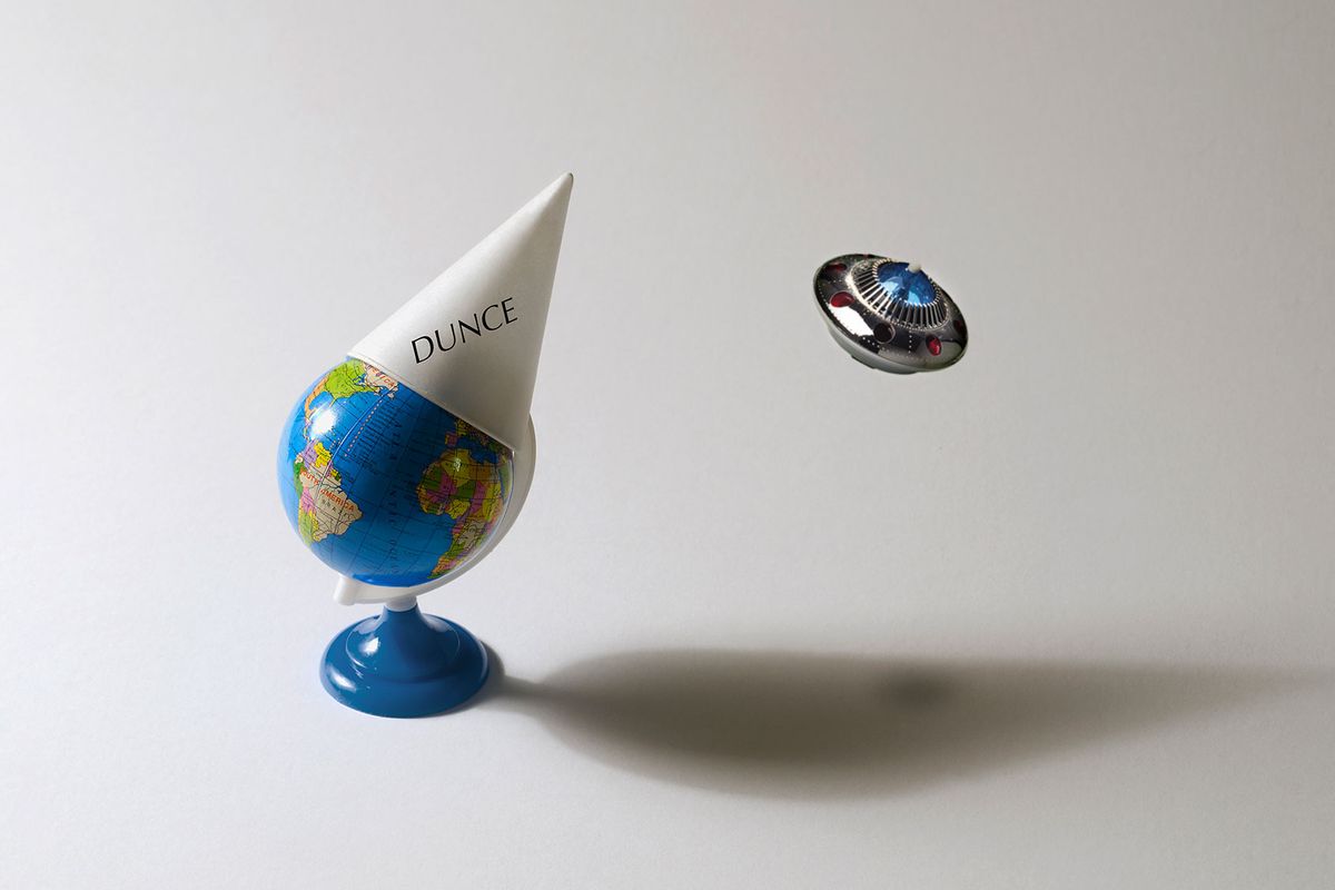 Earth with a dunce cap, and a UFO passing by (Photo illustration by Salon/Getty Images)