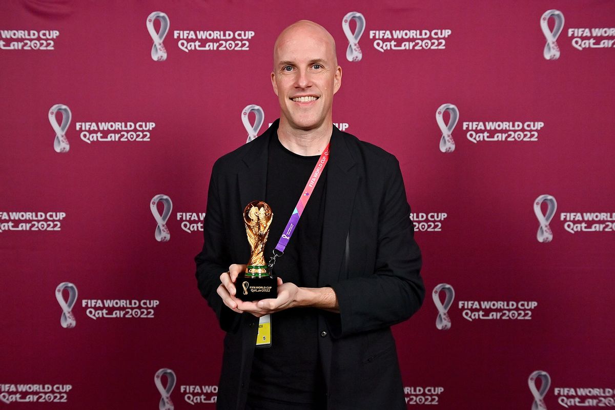 Grant Wahl with a world cup replica trophy, in recognition of their achievement of covering 8 or more FIFA World Cups, during an AIPS / FIFA Journalist on the Podium ceremony at the Main Media Centre on November 29, 2022 in Doha, Qatar. (Brendan Moran/FIFA/Getty Images)