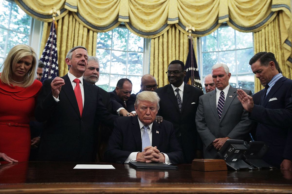 U.S. President Donald Trump, Vice President Mike Pence and faith leaders say a prayer during the signing of a proclamation in the Oval Office of the White House September 1, 2017 in Washington, DC. (Alex Wong/Getty Images)