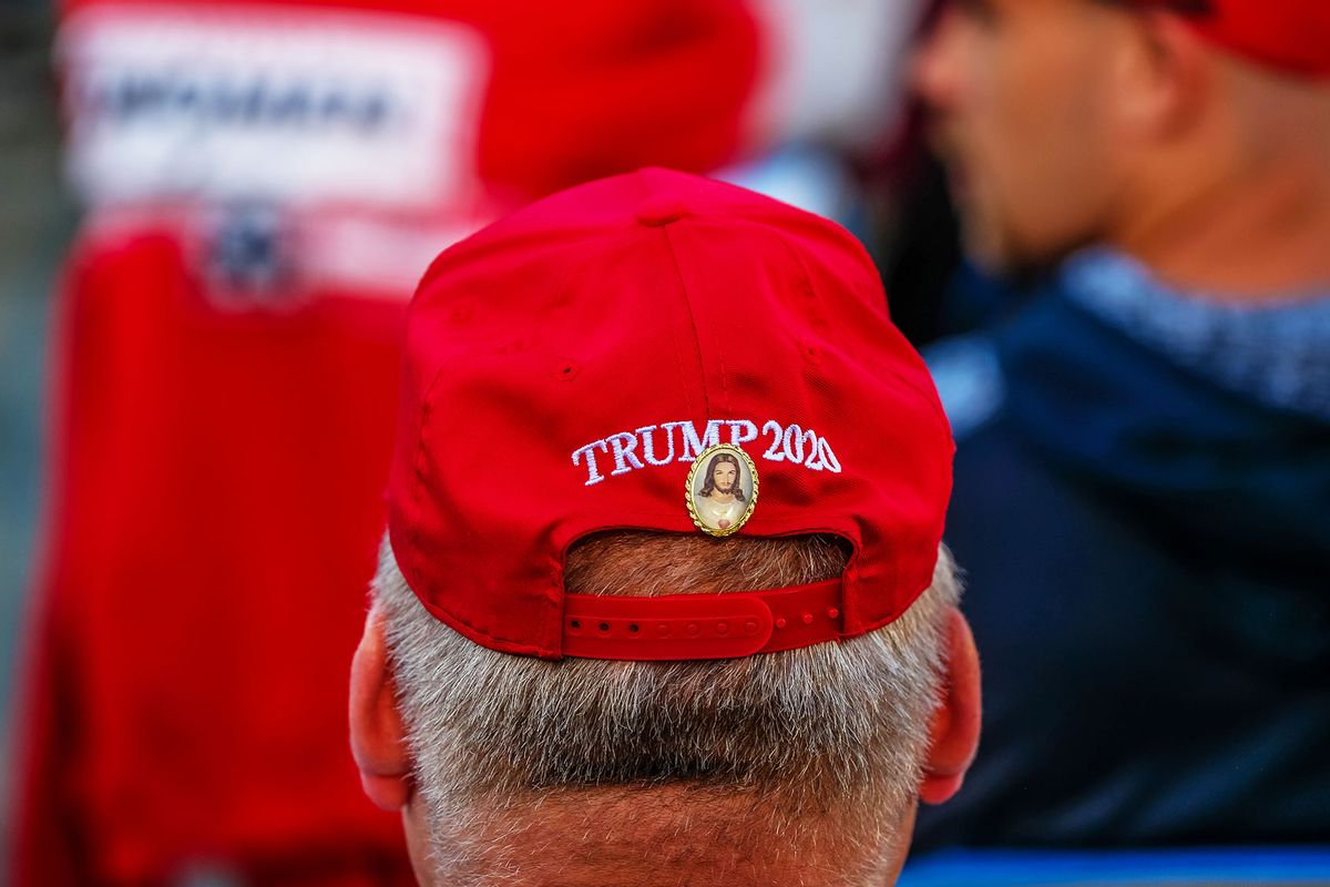 A man has a Jesus Christ pin affixed to a Trump 2020 hat during a Make American Great Again rally. (Preston Ehrler/SOPA Images/LightRocket via Getty Images)