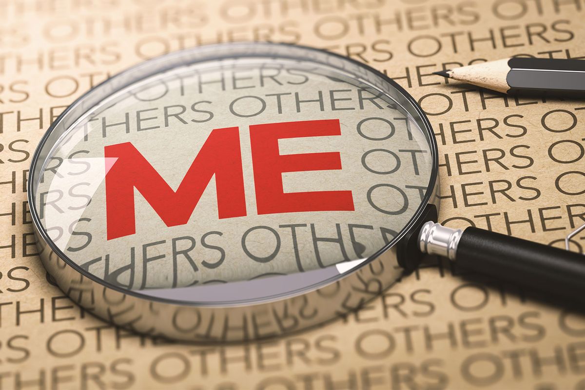 A magnifying glass over a paper background with a focus on the word "Me." (Getty Images/Olivier Le Moal)