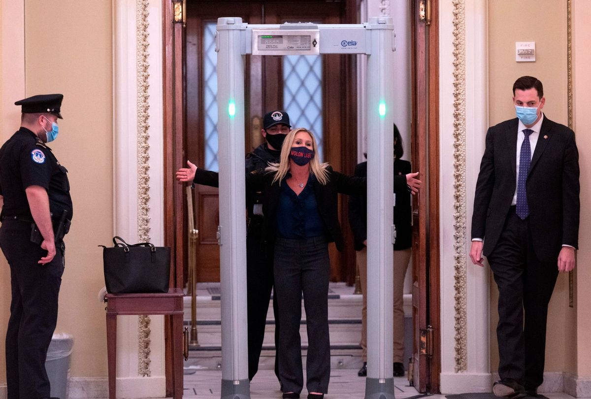 Representative Marjorie Taylor Greene (R-GA) spreads out her arms as she goes through security outside the House Chamber at Capitol Hill in Washington, DC on January 12, 2021. (ANDREW CABALLERO-REYNOLDS/AFP via Getty Images)