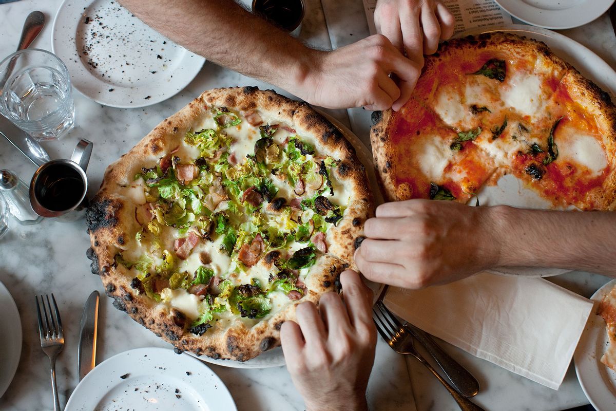 Hands Reach for Naples-Style Pizza (Getty Images/Michael Berman)