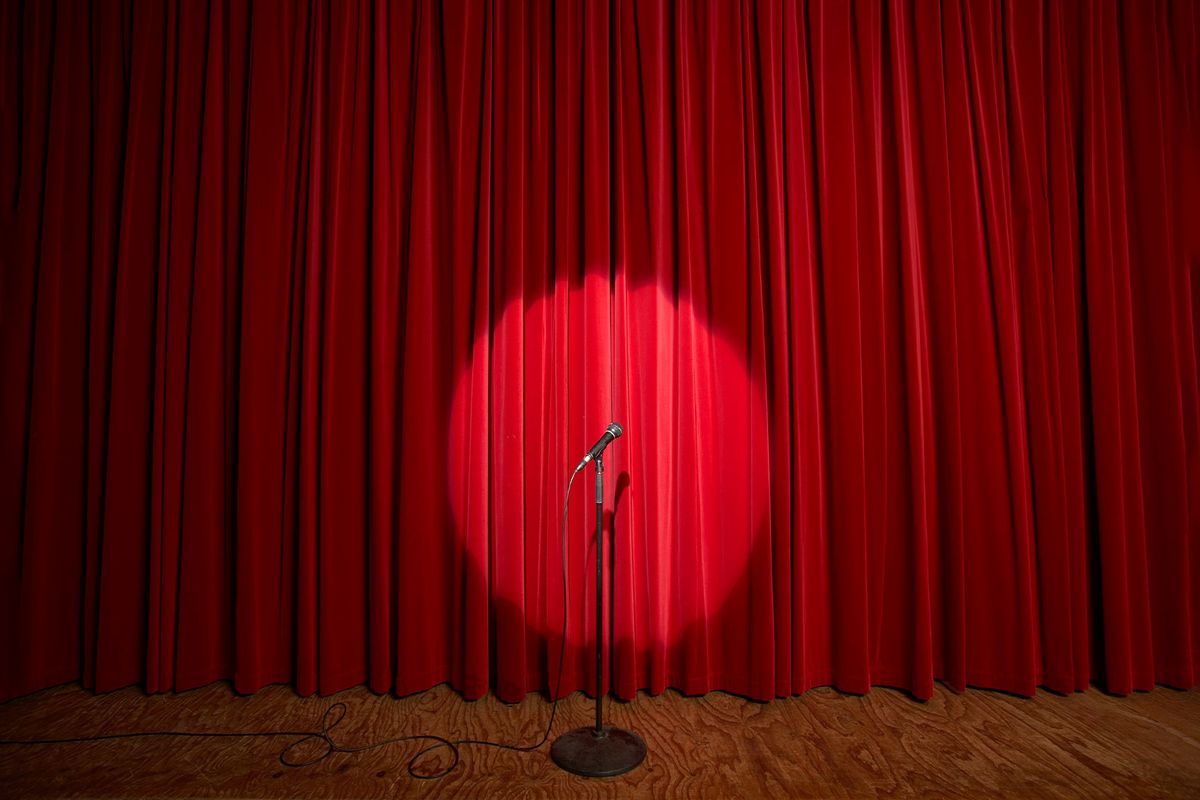 Spotlight on a microphone stand on stage (Getty Images/Adam Taylor)