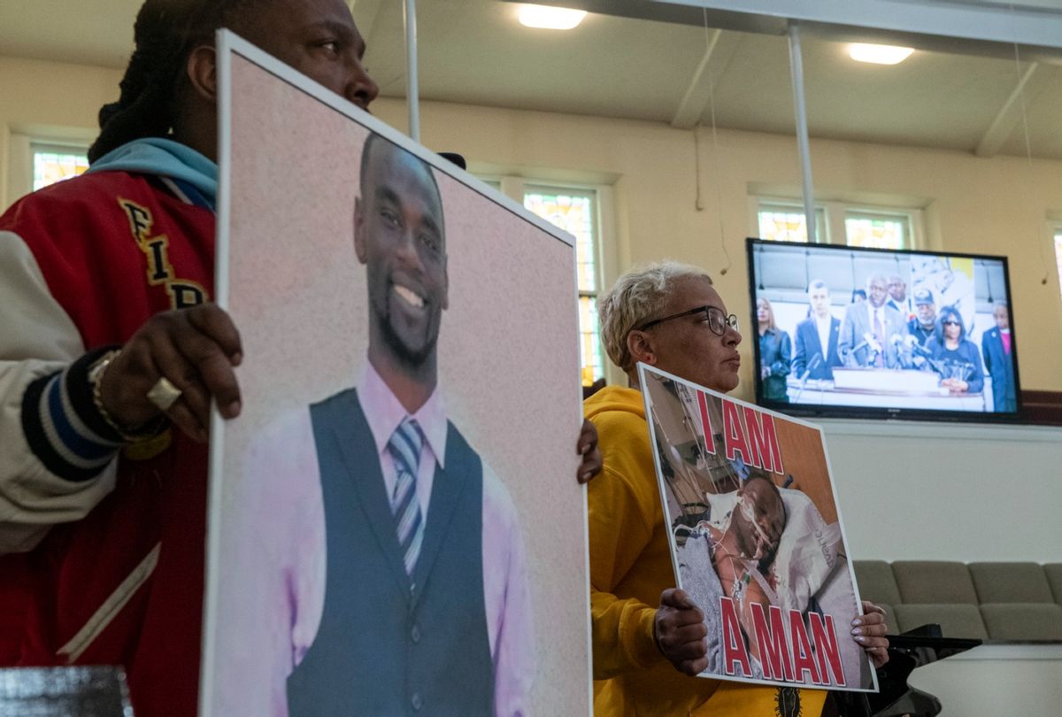 Activists hold signs showing Tyre Nichols as attorney Ben Crump is seen speaking on a monitor during a press conference at Mt. Olive Cathedral CME Church addressing video footage of the violent police encounter that led to Nichols death in Memphis, TN on January 23, 2023. ( Brandon Dill for The Washington Post via Getty Images)
