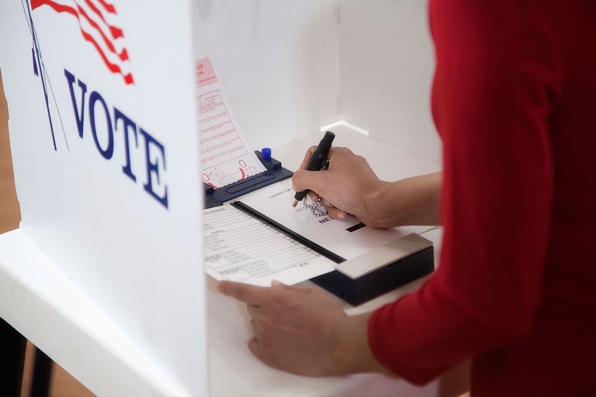 Voter voting in a polling place (Getty Images/Hill Street Studios)