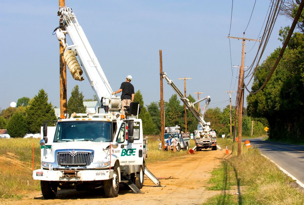 Baltimore Gas & Electric trucks hooking up power lines. (HUM Images/Universal Images Group via Getty Images)