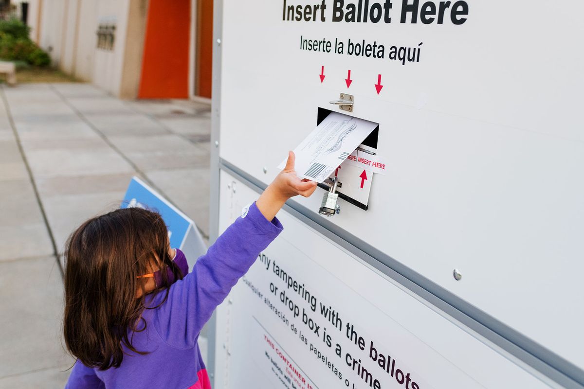 Little girl placing ballot in a drop box for absentee voting (Getty Images/Cavan Images)