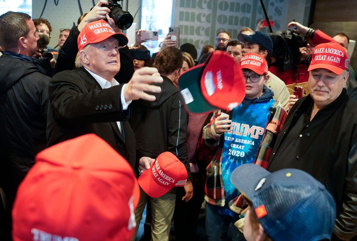 Former President Donald Trump hands out Make America Great Again hats to McDonald's employees on Wednesday, February 22, 2023 in East Palestine, Ohio. (Jabin Botsford/The Washington Post via Getty Images)