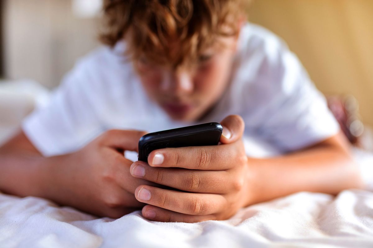Teenage boy is using smartphone at home in bed (Getty Images/EMS-FORSTER-PRODUCTIONS)