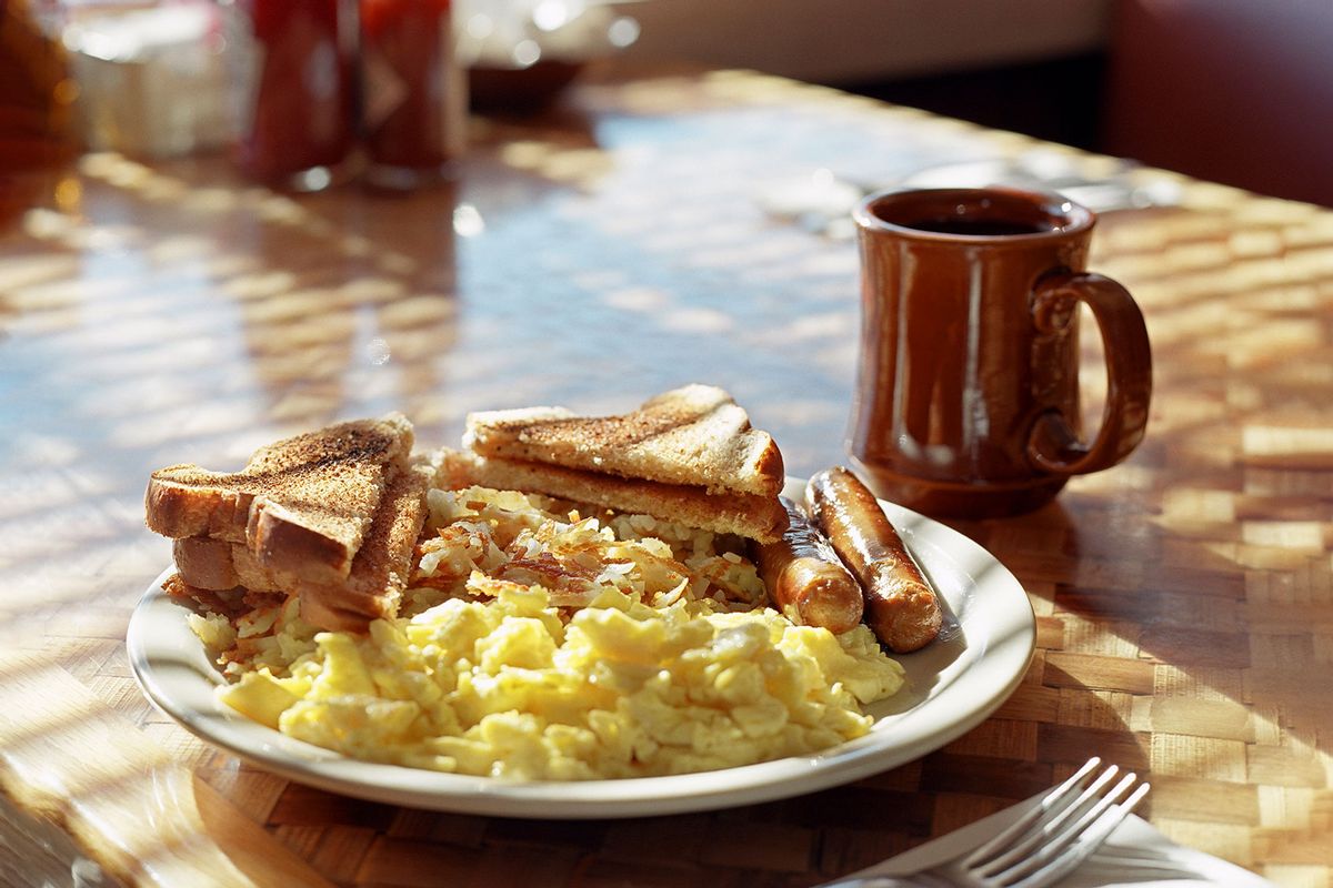 Diner breakfast of scrambled eggs, sausages, hash brown, toast and coffee (Getty Images/Gary Yeowell)