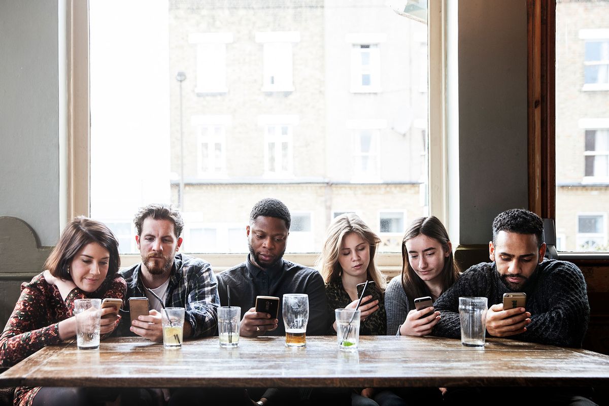 Friends at a pub all on their phones (Getty Images/Henrik Sorensen)
