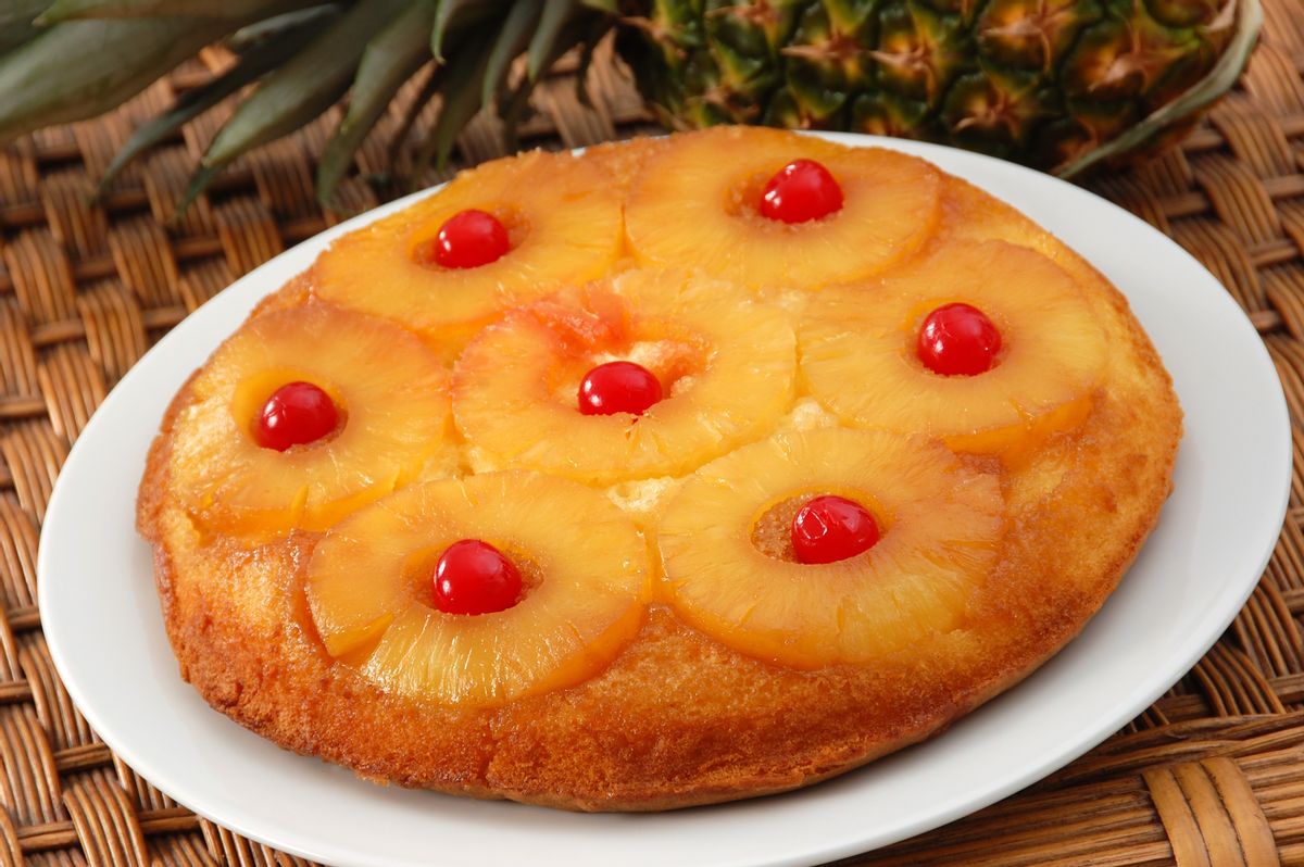 Pineapple upside down cake garnished with maraschino cherries. (sbossert/Getty Images)