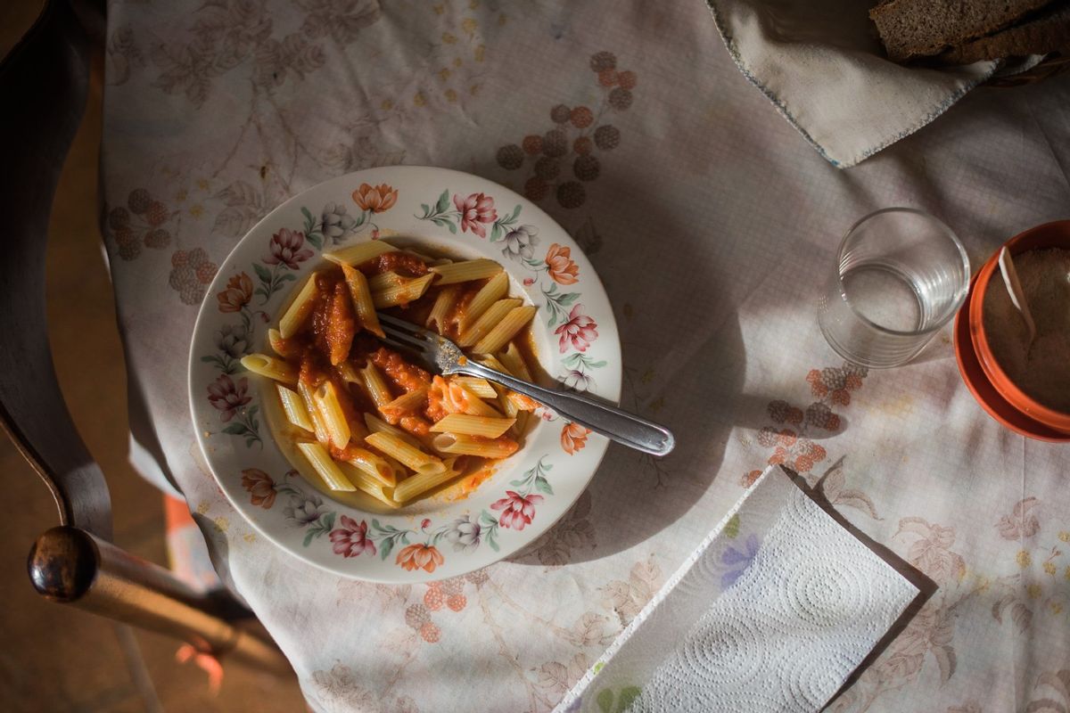 Dish of pasta with tomato sauce left on the table. (Stefania Pelfini/La Waziya Photography/Getty)