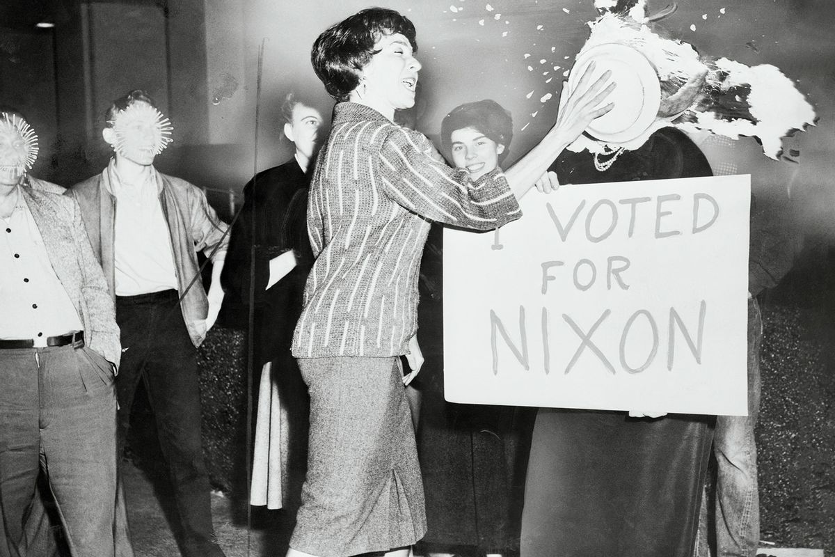 Tybie Paul shoves a banana cream pie into the face of Georgiana Walker at the corner of Hollywood and Vine. Miss Walker holds a sign that reads "I Voted For Nixon." (Getty Images/Bettmann)
