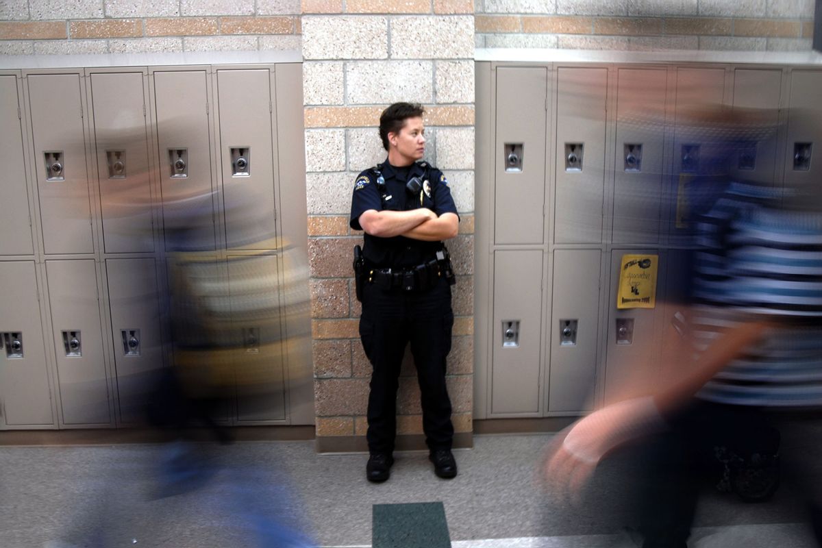 Broomfield police school resource officer patrols a hallway at Legacy High School. (David Jennings/Digital First Media/Boulder Daily Camera via Getty Images)