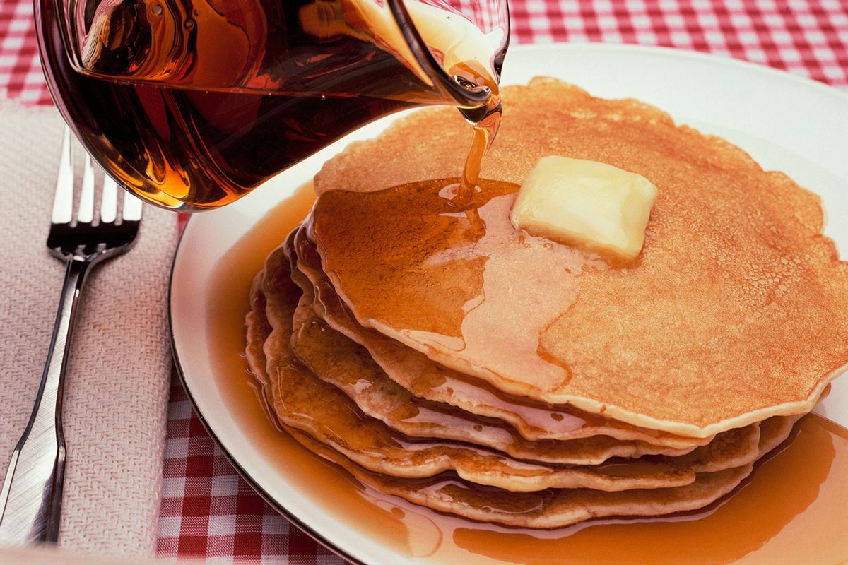 Pouring Maple Syrup on Plate of Pancakes (Getty Images/Roy Morsch)