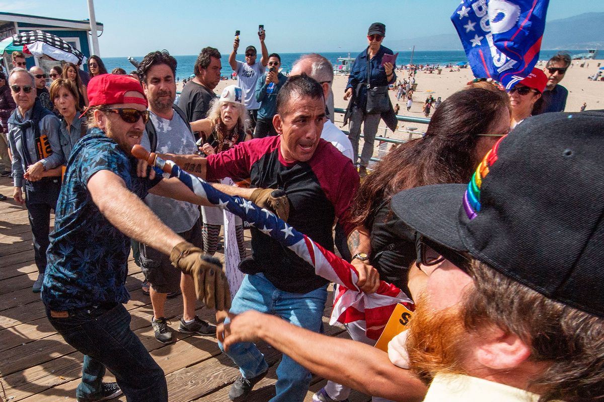 Supporters of President Donald Trump (L) clash with anti-Trump protesters during a rally against his policies in Santa Monica, California on October 19, 2019. (MARK RALSTON/AFP via Getty Images)