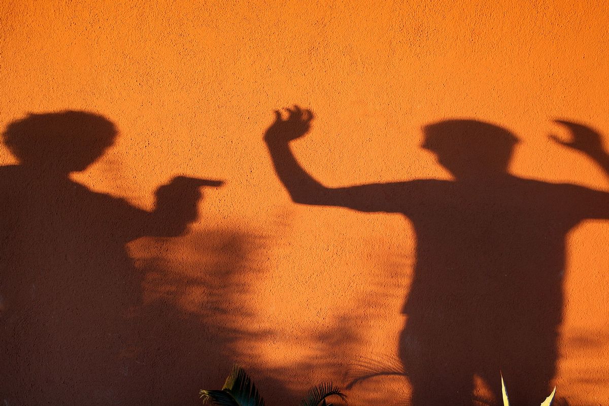 Two humans in a gun fight (Getty Images/Hélène Desplechin)