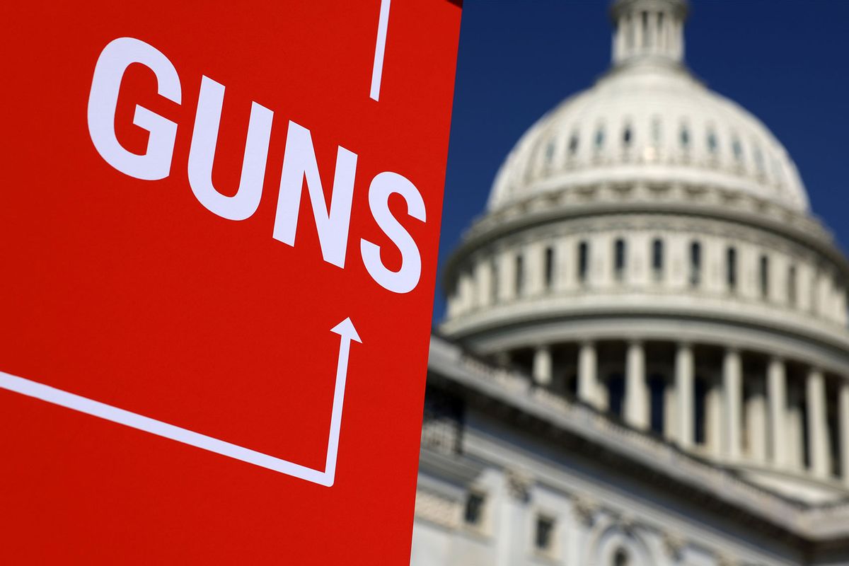 A sign that read "Guns" is on display as House Democrats gather for an event on gun violence at the East Front of the U.S. Capitol on March 29, 2023 in Washington, DC. (Alex Wong/Getty Images)
