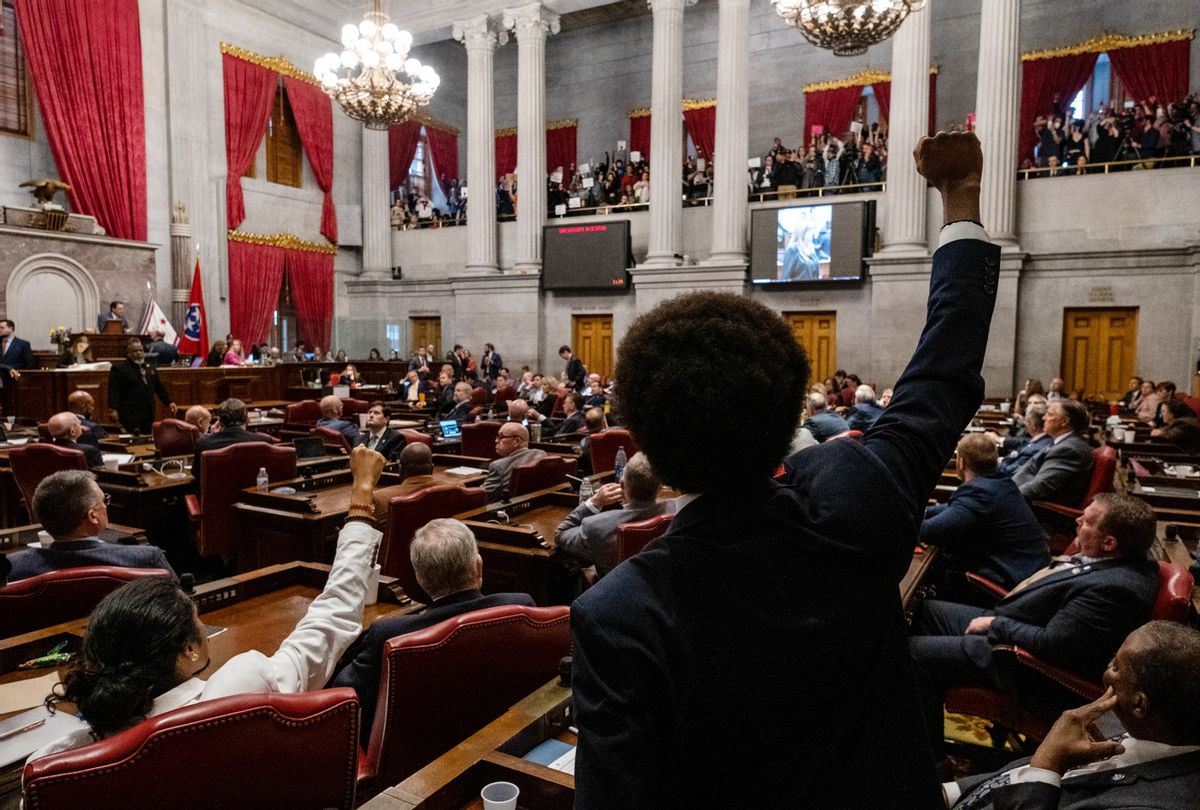 Democratic state Reps. Justin Jones (Lower, L) of Nashville and Justin Pearson (C) of Memphis gesture to supporters during the vote in which they were expelled from the state Legislature on April 6, 2023 in Nashville, Tennessee.  (Seth Herald/Getty Images))