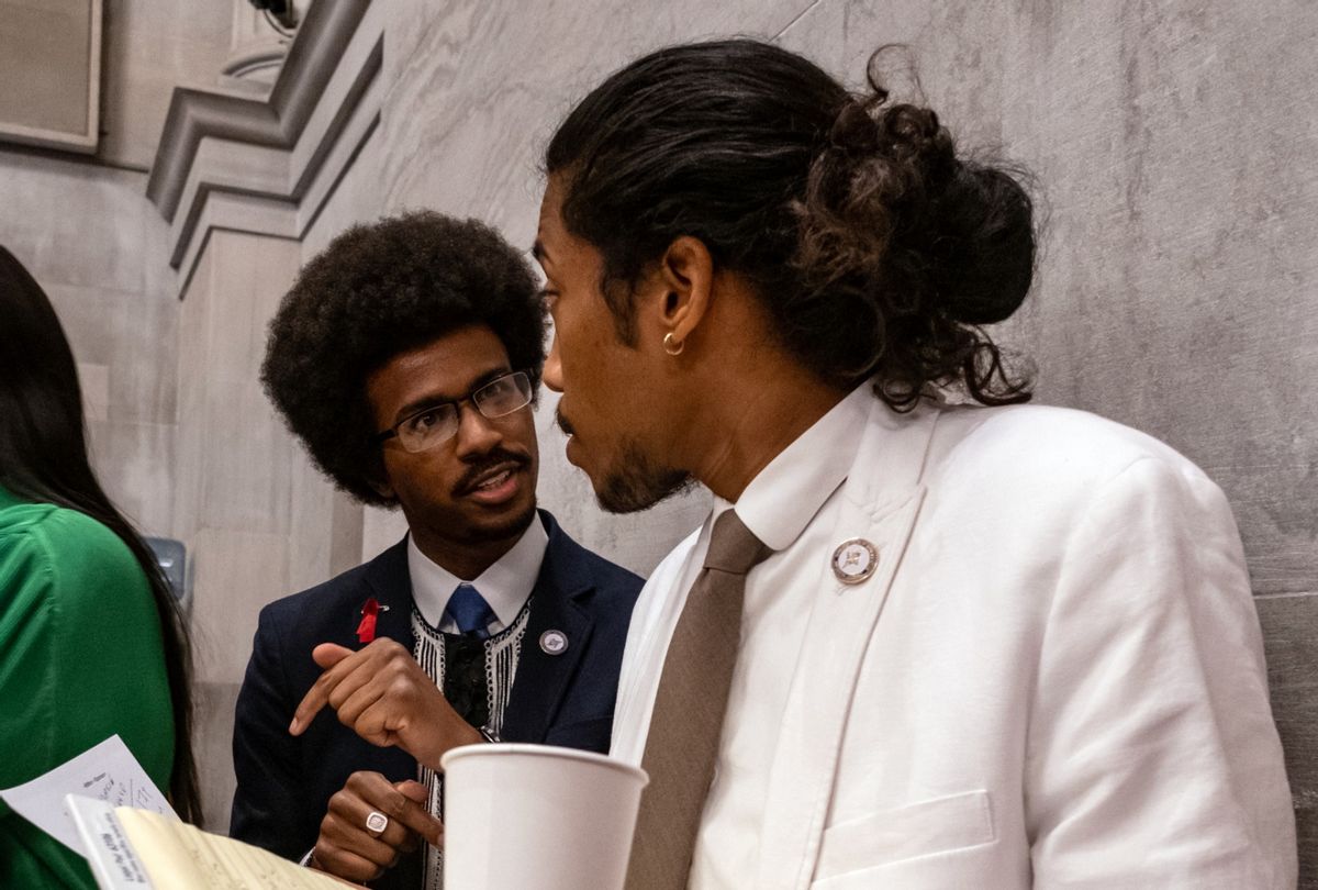 Democratic state Reps. Justin Pearson (C) of Memphis and Justin Jones (R) of Nashville attend the vote in which they were expelled from the state Legislature on April 6, 2023 in Nashville, Tennessee. (Seth Herald/Getty Images)